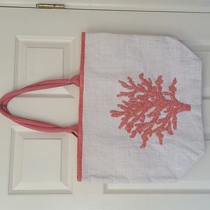 Beach bag with beaded coral on front.